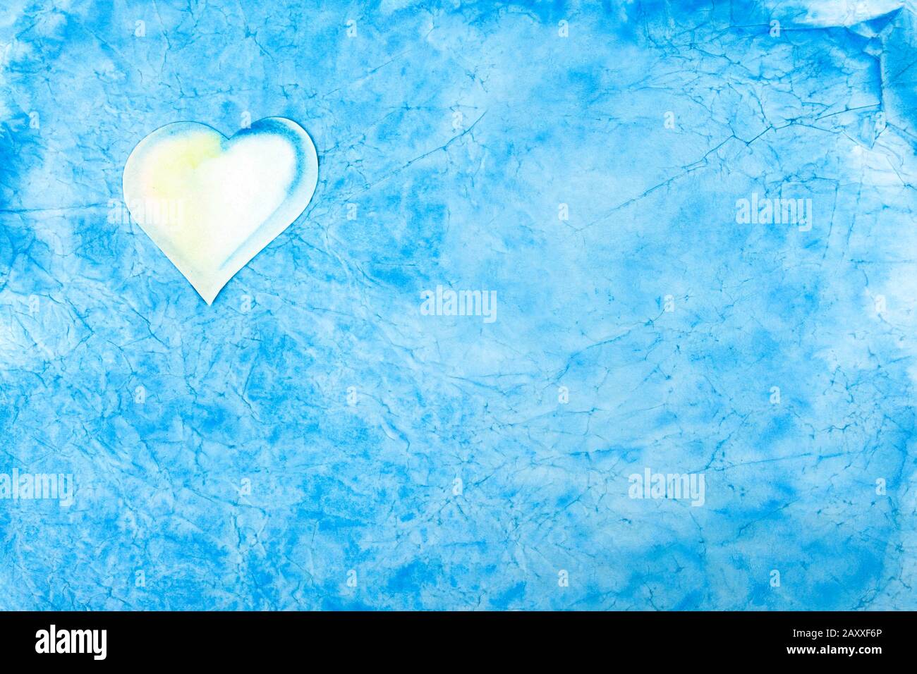 Simple light blue abstract cloud like background texture with a small white heart in the corner. Calm serene wallpaper, greetings card, postcard Stock Photo