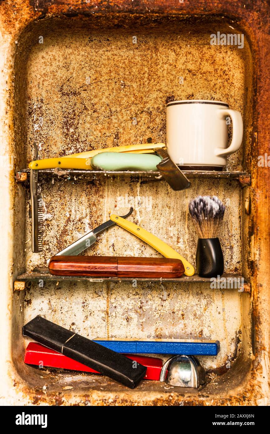 A Vintage Rusty Bathroom Medicine with some Barber Tools like a