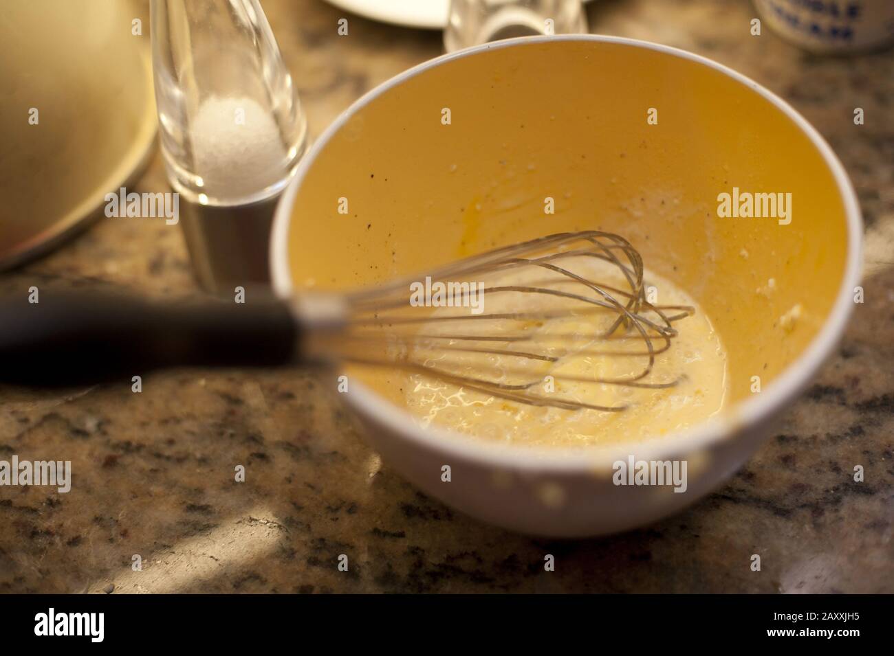 https://c8.alamy.com/comp/2AXXJH5/metal-whisk-in-a-mixing-bowl-with-whisked-egg-on-a-kitchen-table-reading-for-baking-2AXXJH5.jpg