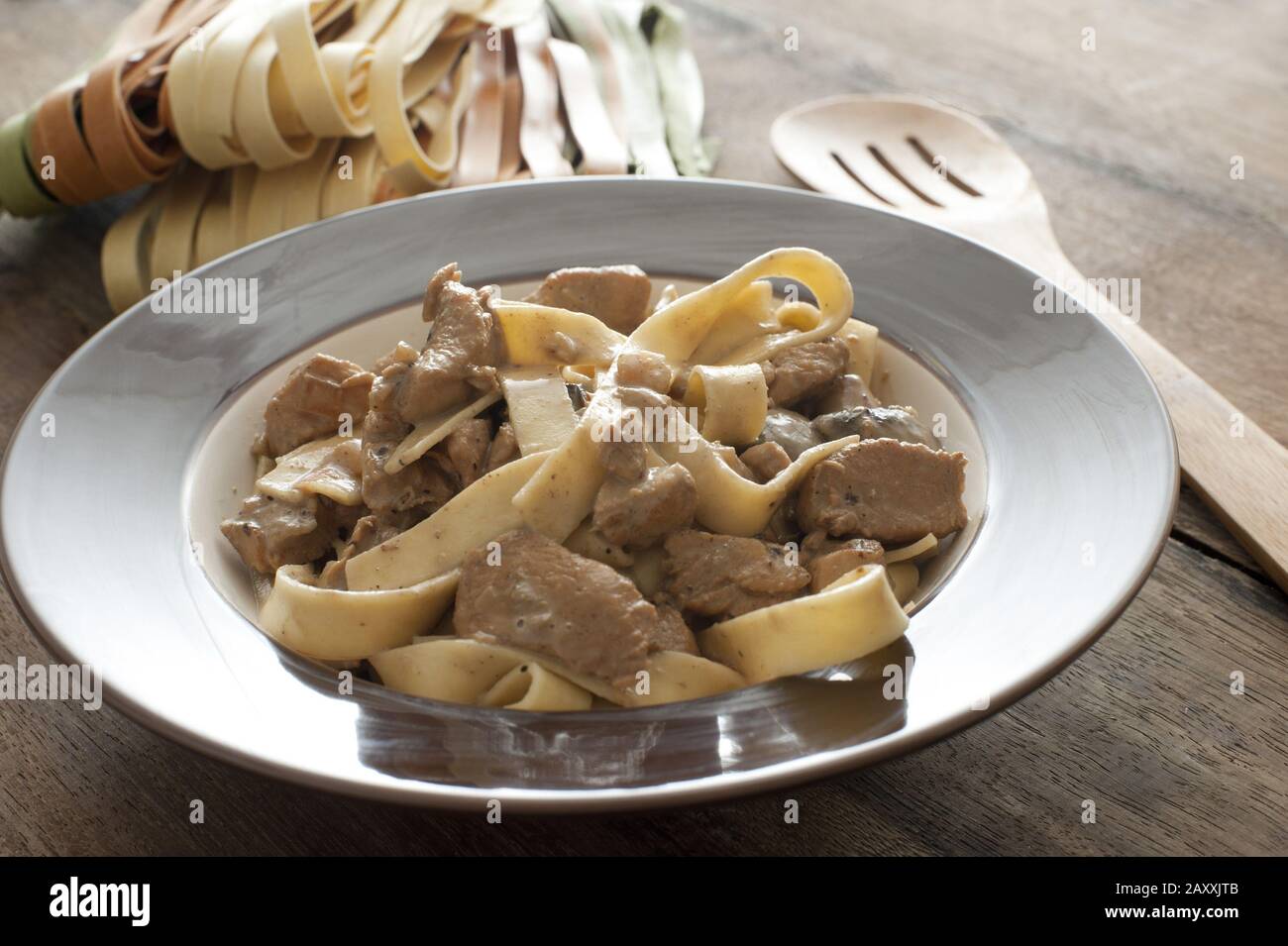 A bowl of mhmemade chicken tagliatelli carbonara Stock Photo