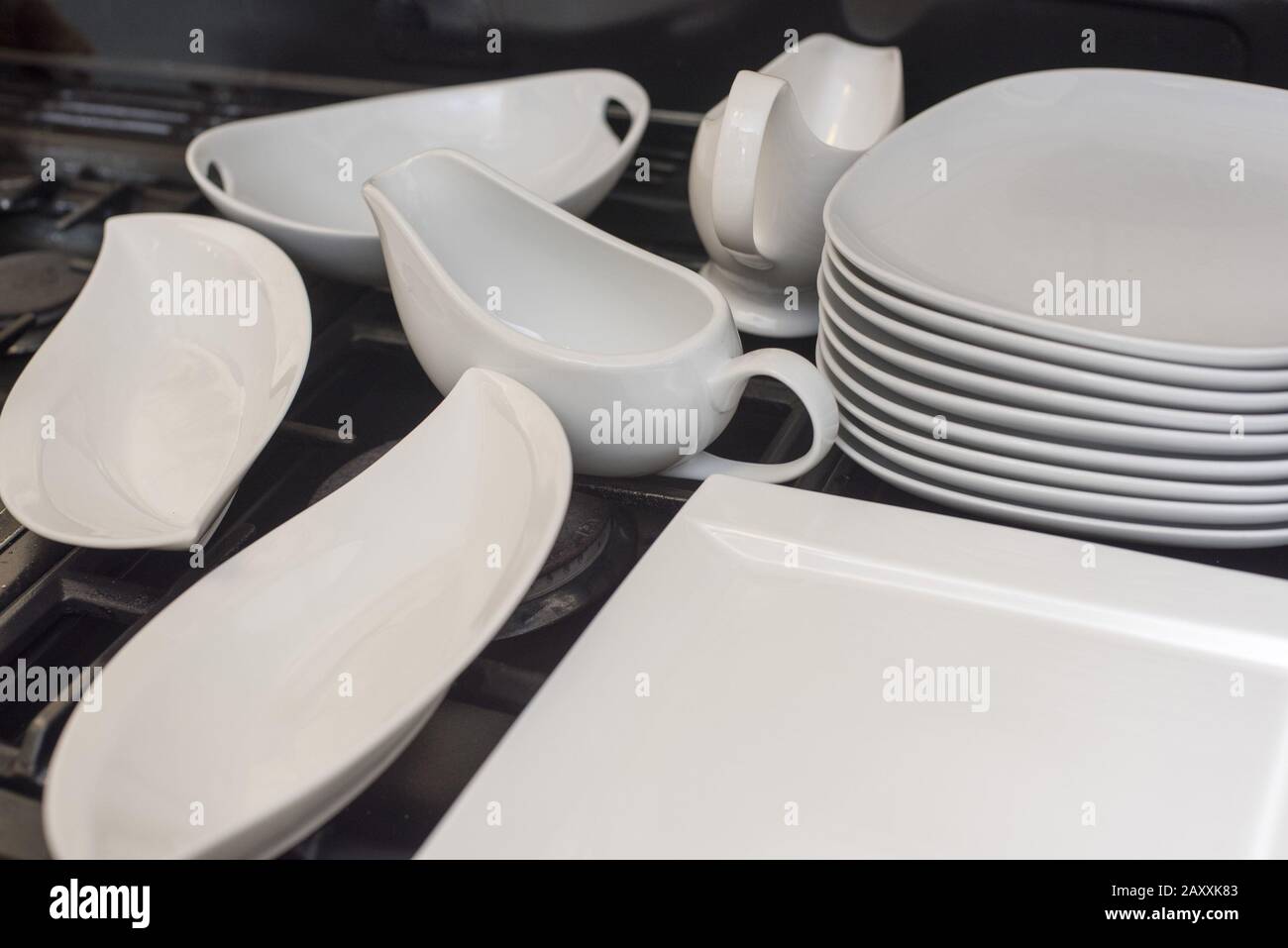 Generic white dinnerware set with assorted plates, jugs and gravy boats ready to serve food