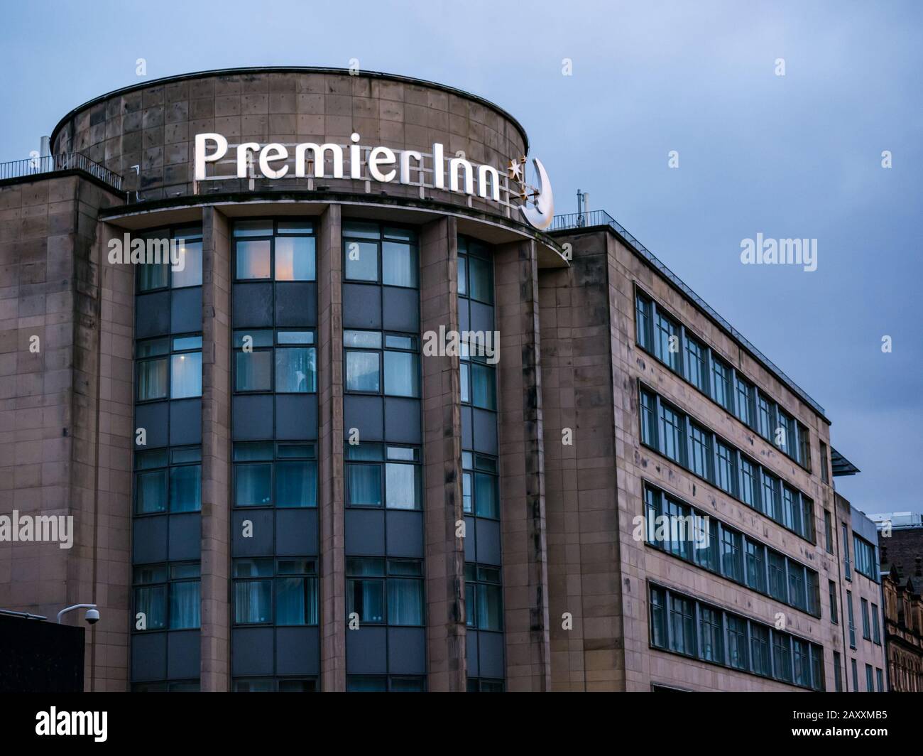 Premier Inn lit neon name sign at dusk, George Street, Glasgow, Scotland, UK Stock Photo