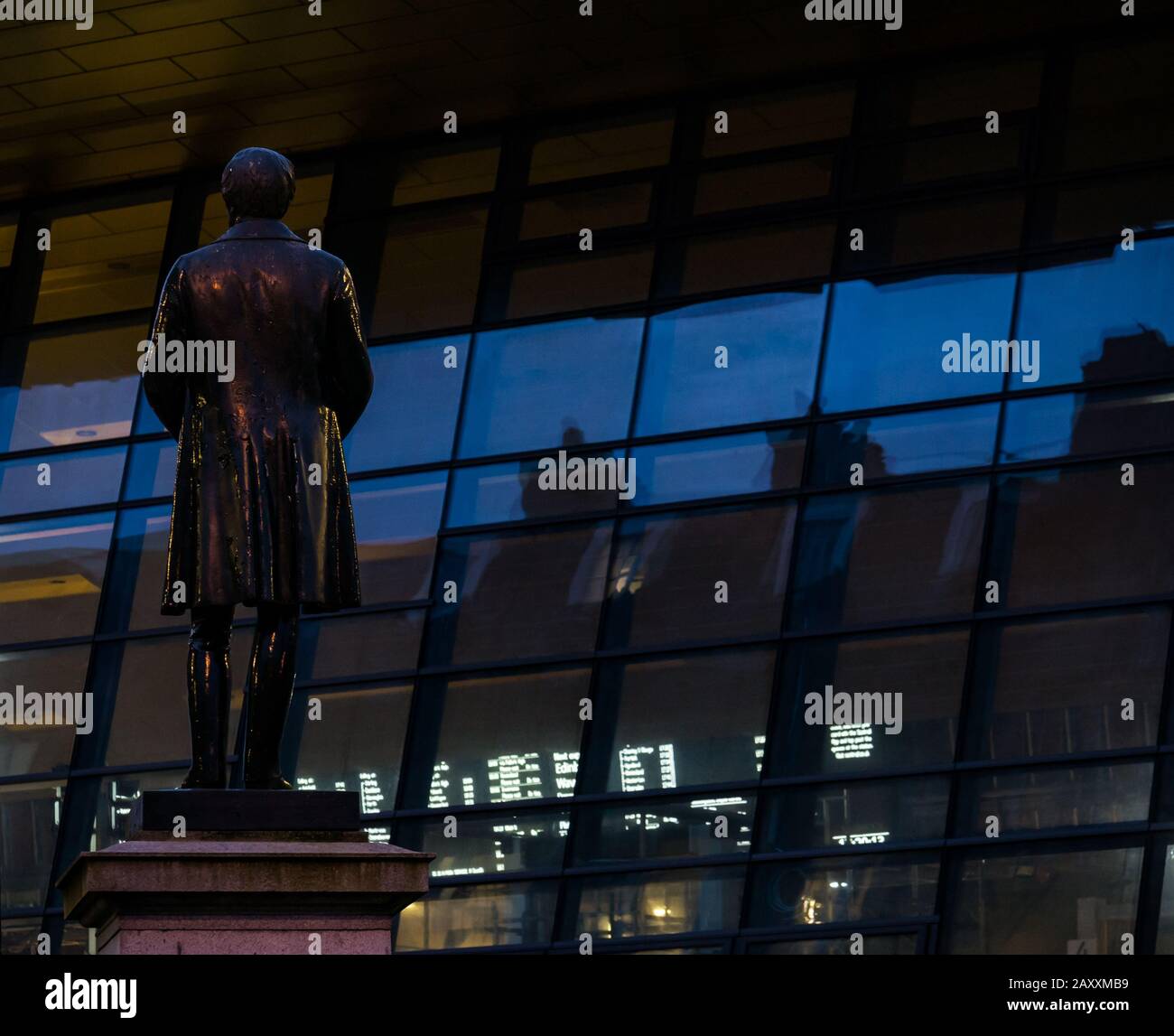 Robert Peel statue with new facade of Queen Street train station at dusk, George Square, Glasgow, Scotland, UK Stock Photo