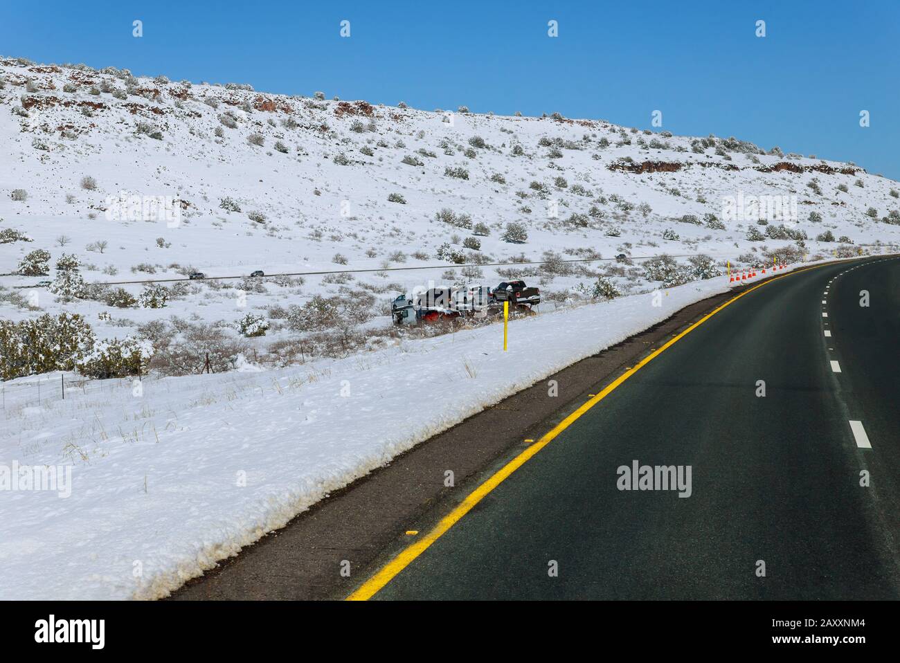 Drift of the car carrier trailer truck transports cars on highway with accident in snow off road Stock Photo