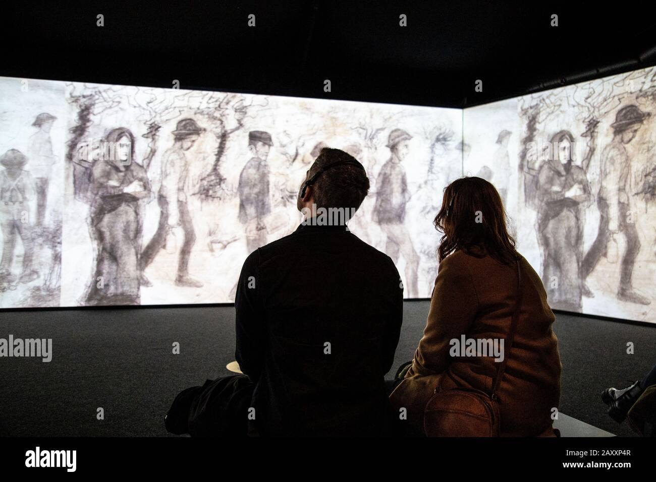 People wearing headphones watching and listening to an audioguide at an immersive interactive exhibition, Meet Vincent van Gogh Experience, London, UK Stock Photo