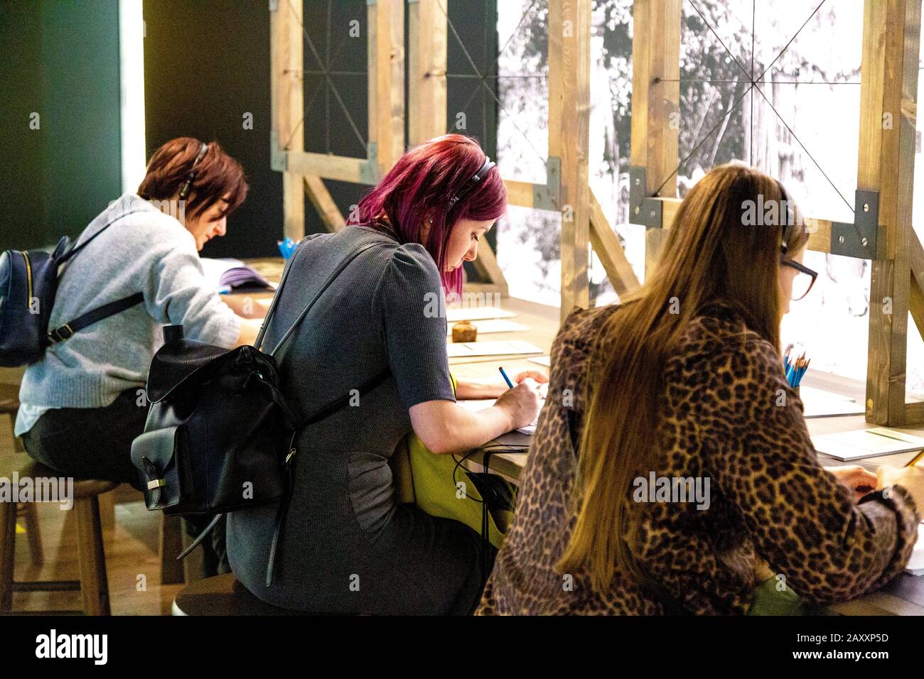 People drawing with use of perspective frames at Meet Vincent van Gogh Experience, London, UK Stock Photo