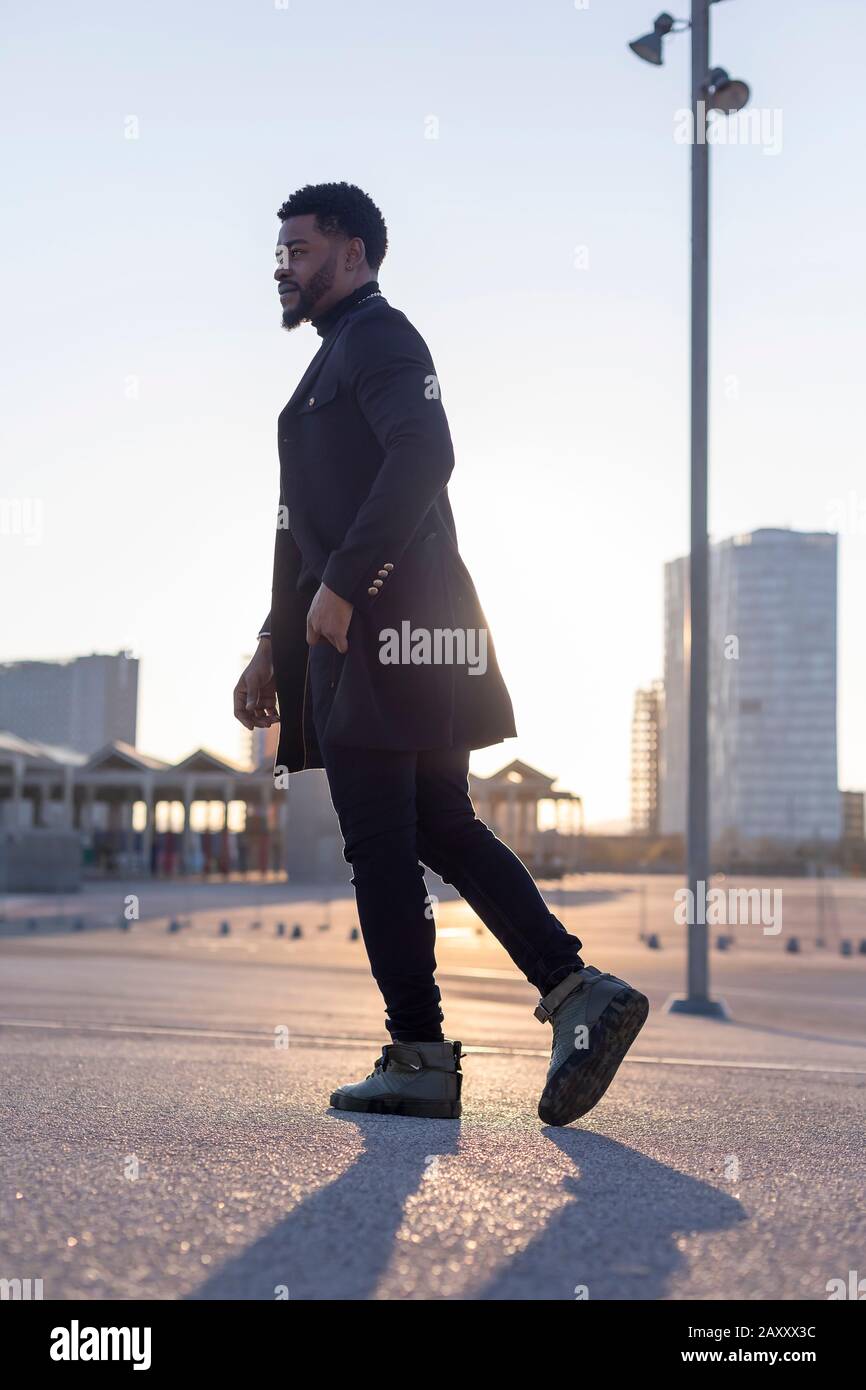 Young black man walking afro hi-res stock photography and images - Alamy