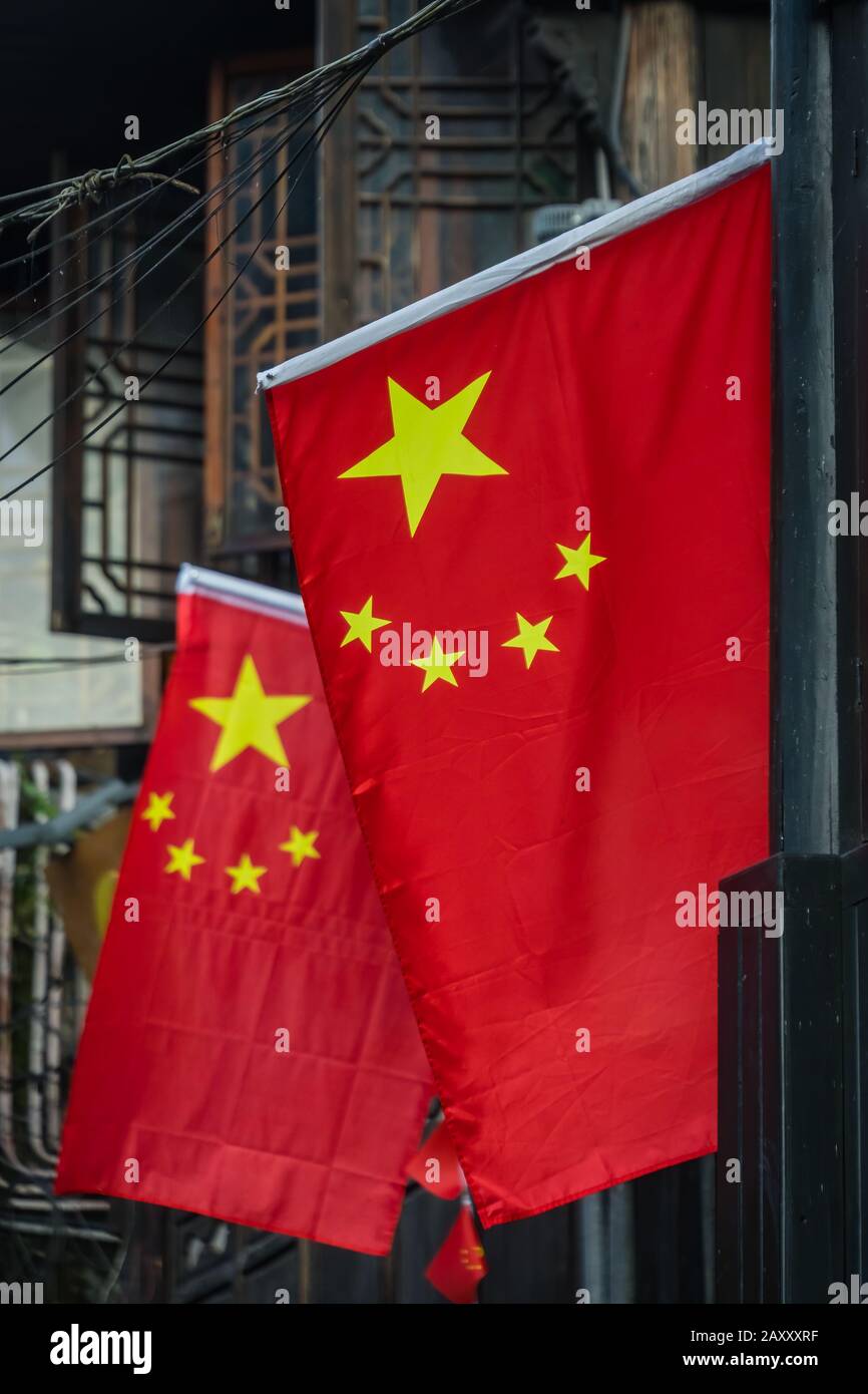 Chinese flag flutering above narrow street in the Old town of Fenghuang,  known as Phoenix town, Hunan Province, China Stock Photo - Alamy