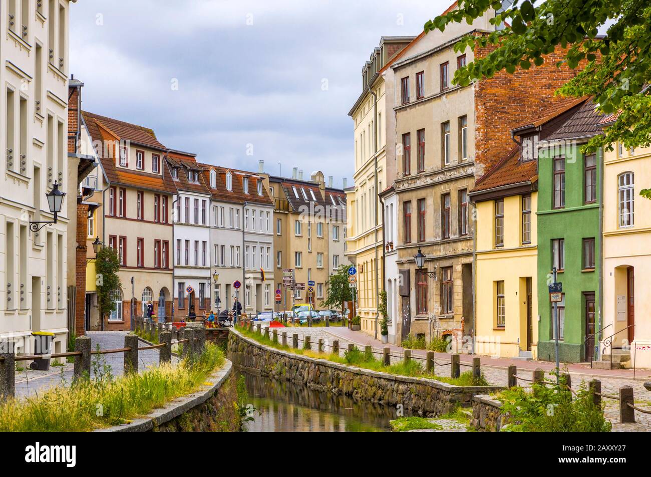 On the streets of Wismar old town. Colorful houses along the canal of Grube river, Wismar city, Mecklenburg-Vorpommern state, Germany Stock Photo