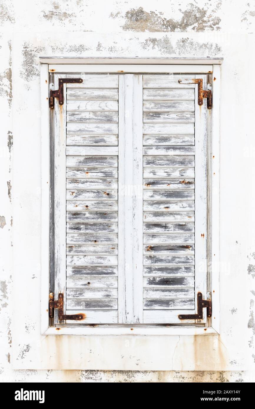 White weathered rusted wooden window shutters Stock Photo - Alamy