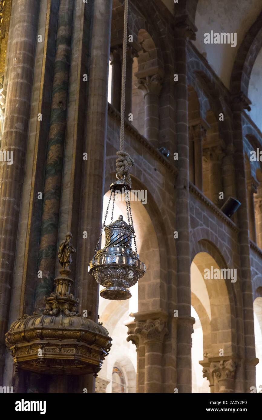 The Botafumeiro hangs in the central nave of the cathedral in Santiago de Compostela, Spain. The famous silver thurible is swung in a ritual that has Stock Photo
