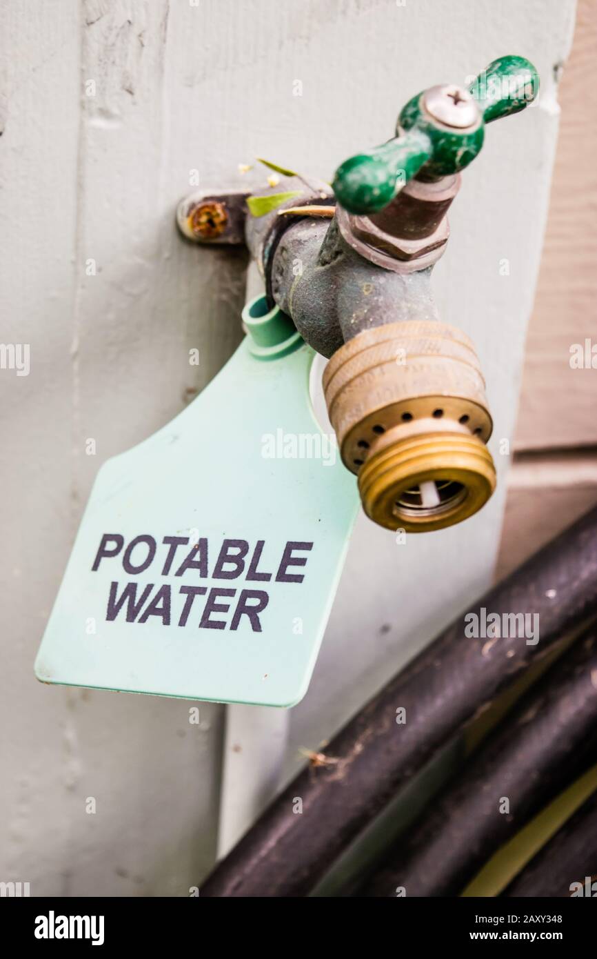 Closeup Of Outdoor Faucet With Potable Water Tag Stock Photo