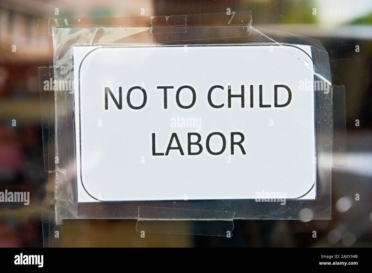 Photocopied sign with 'No To Child Labor' posted on an entrance glass door of a business establishment, seen in Iloilo City, Philippines, Asia Stock Photo