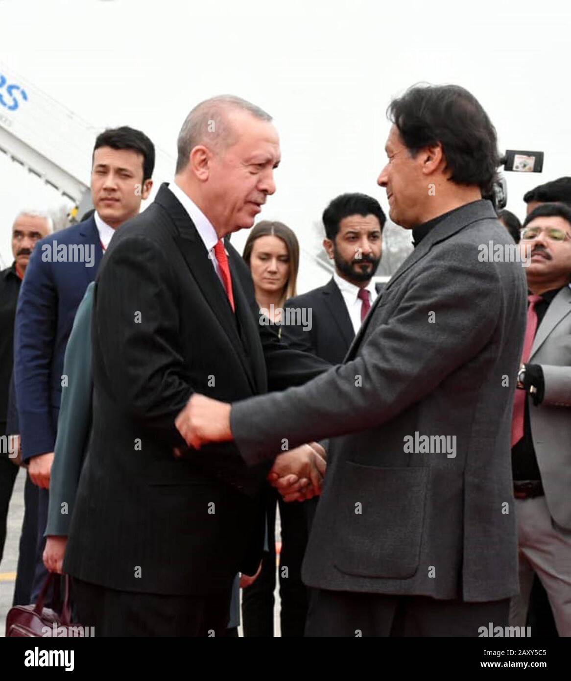 (200214) -- ISLAMABAD, Feb. 14, 2020 (Xinhua) -- Photo released by Pakistan's Press Information Department (PID) shows Pakistani Prime Minister Imran Khan (R) shaking hands with Turkish President Recep Tayyip Erdogan upon his arrival in Islamabad, Pakistan, Feb. 13, 2020. Turkish President Recep Tayyip Erdogan on Thursday arrived in Pakistan for a two-day visit. (PID/Handout via Xinhua) Stock Photo