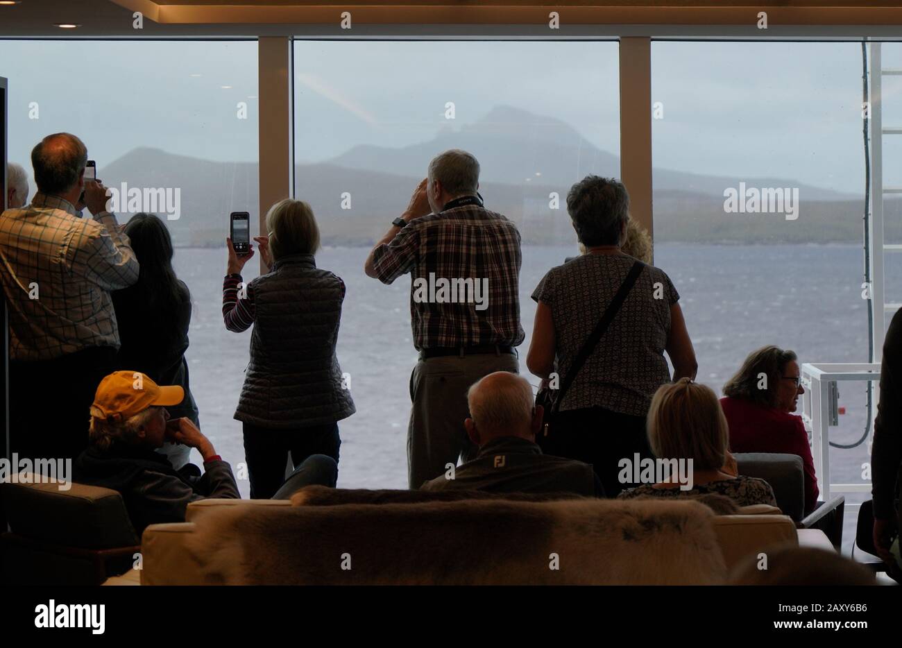 Cruising tourists photograph cape horn the southern tip of south