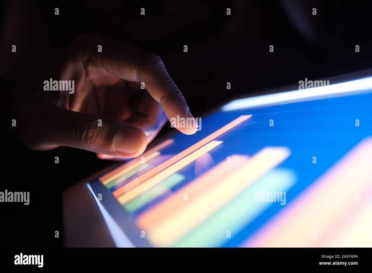man analyzing chart on digital tablet. Using self created chart  Stock Photo