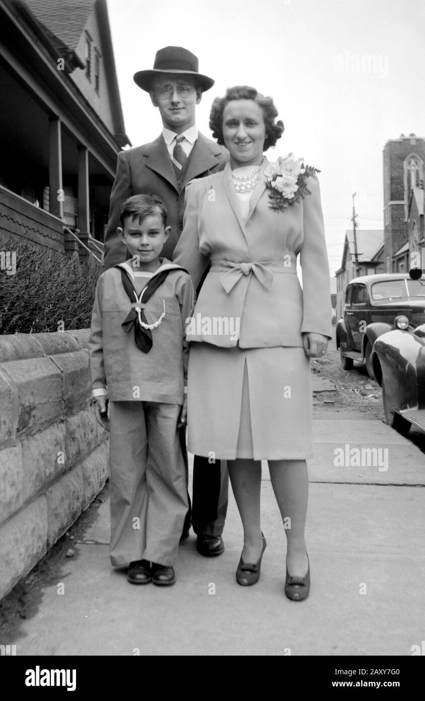 Couple with their son pose on the sidewalk, ca. 1935. Stock Photo