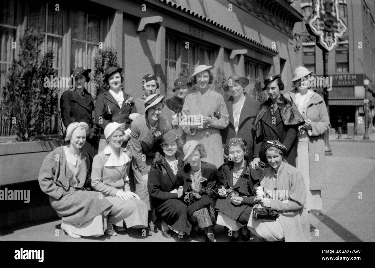 A group of shopping women pose on the sidewalk, ca. 1938. Stock Photo