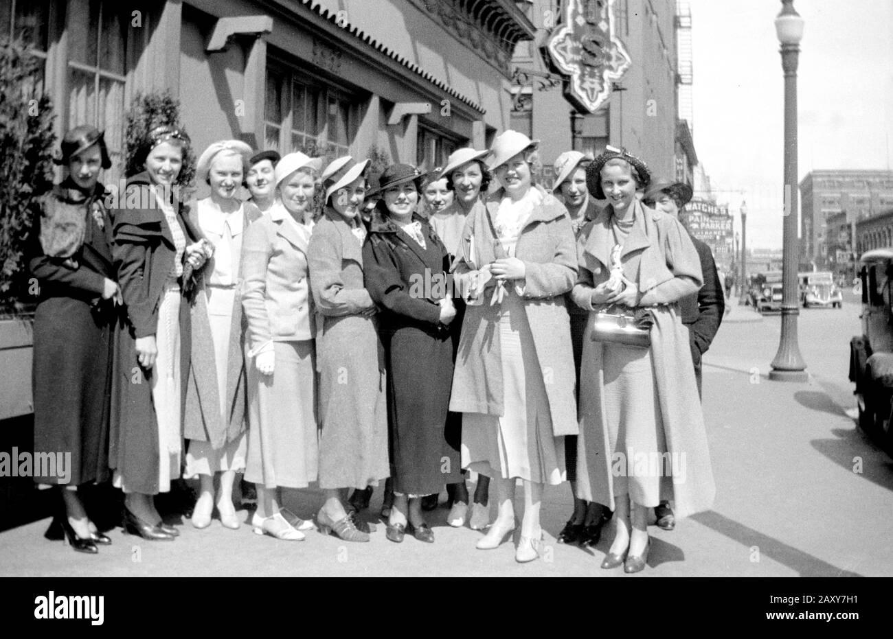 A group of shopping women pose on the sidewalk, ca. 1938. Stock Photo