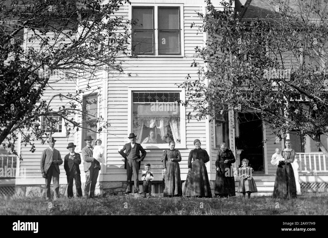 The extended family stands outside their farmhouse on American Great Plains, ca. 1905. Stock Photo