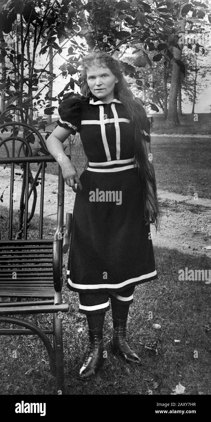 An older woman is ready to go swimming in her period swimsuit, ca. 1905. Stock Photo