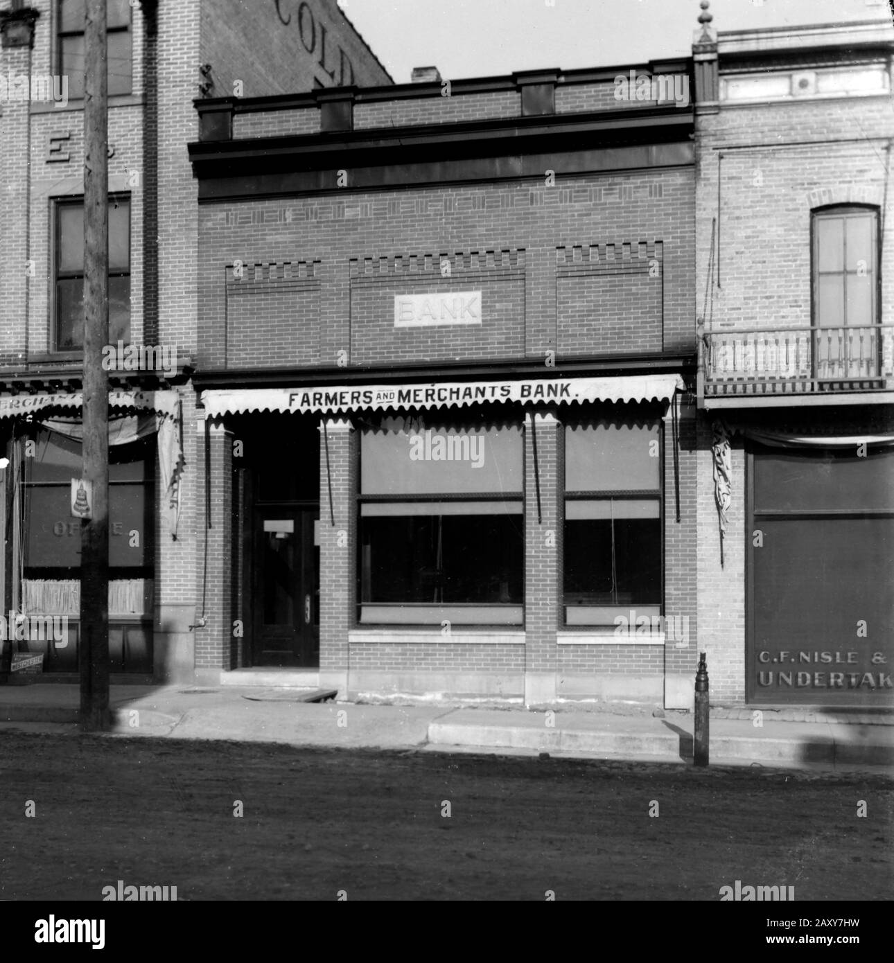 A Farmers and Merchants Bank in a small American town on the Great Plains, ca. 1930. Stock Photo