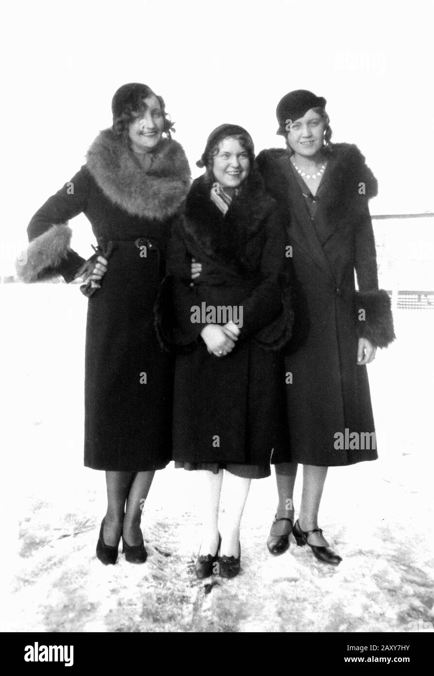 Three fashionable women brave the snow and ice to pose for portrait, ca. 1928. Stock Photo