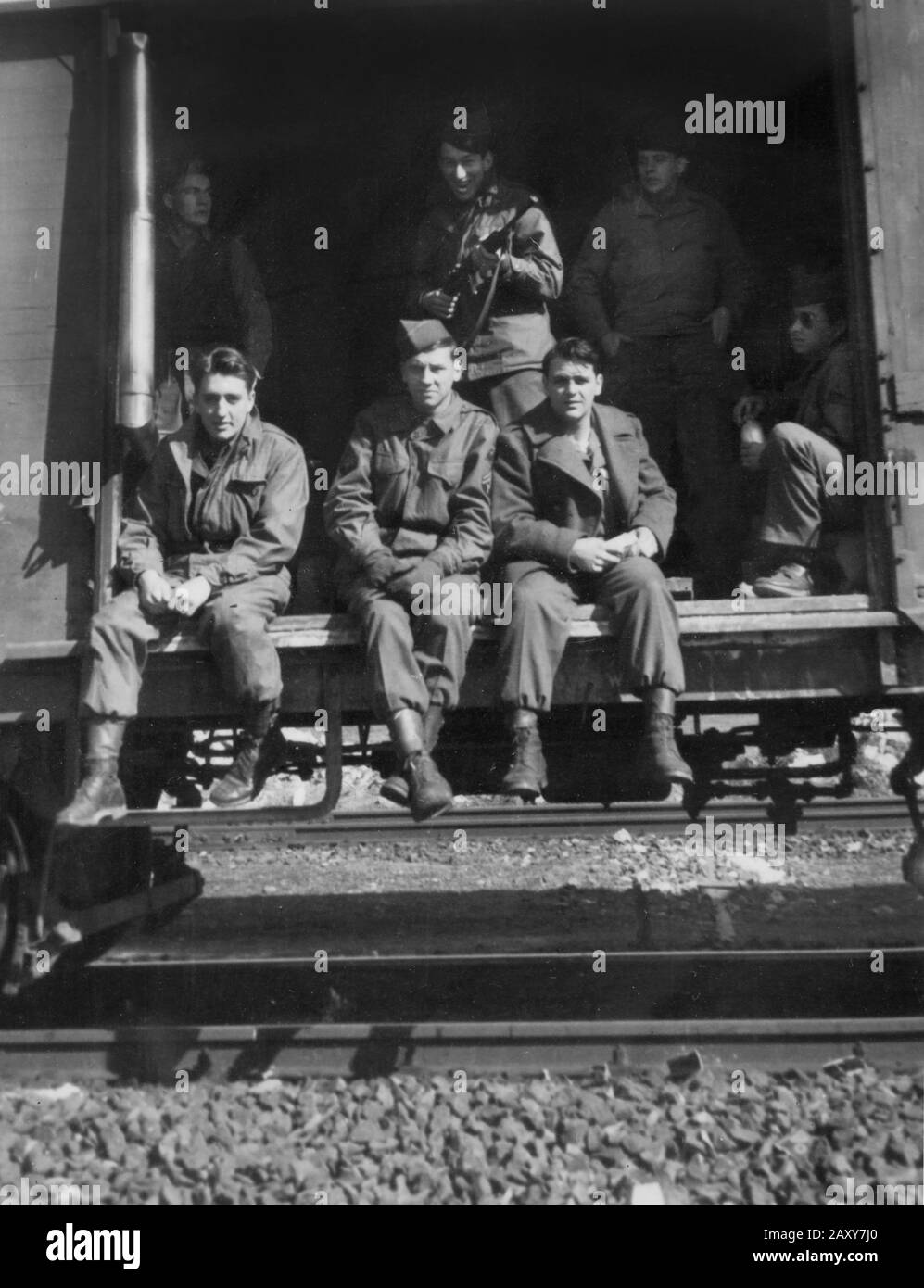 A group of American GIs waiting on a troop transport train during World War II. Stock Photo