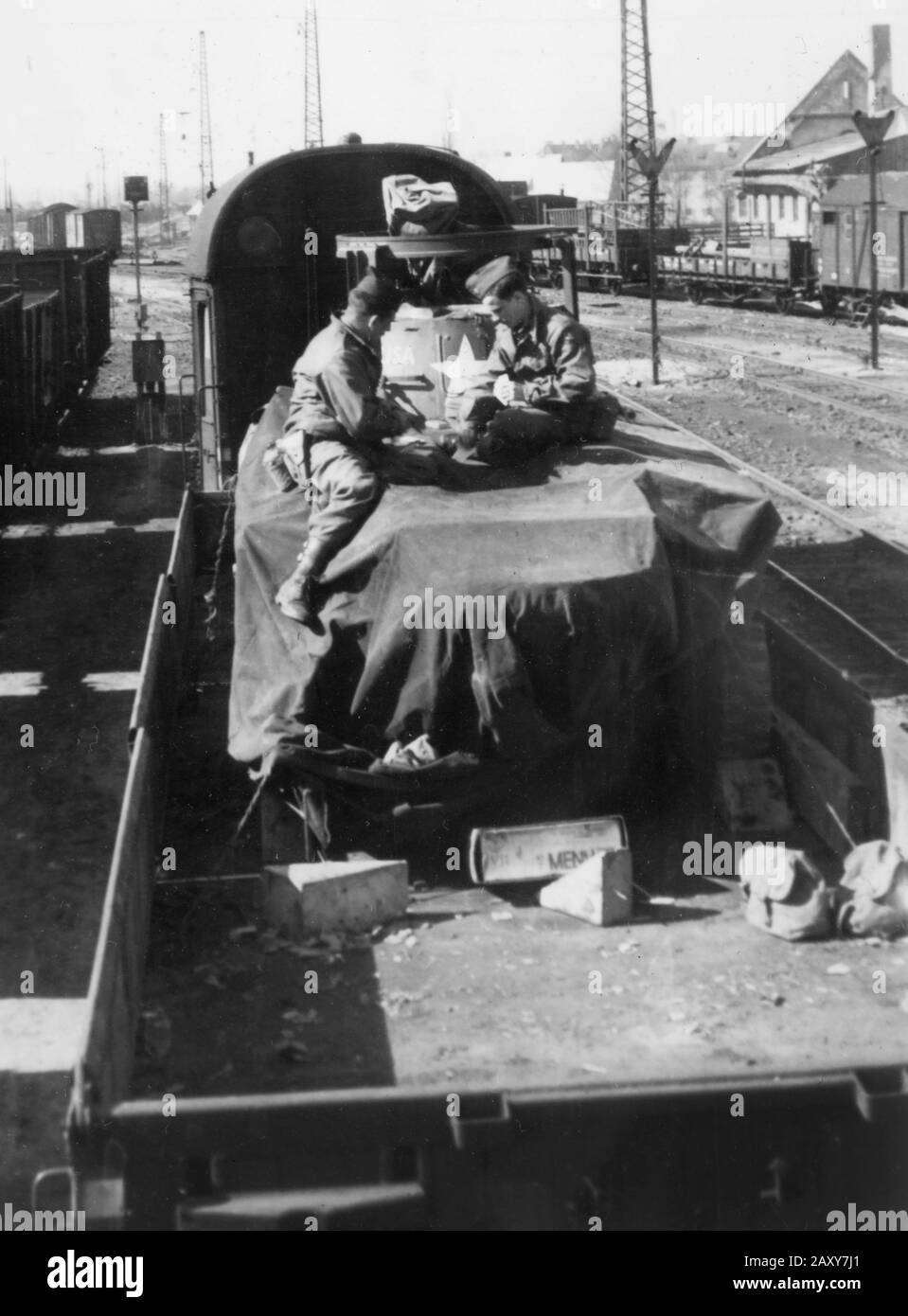 Two American GIs play cards atop a transport train during World War II. Stock Photo