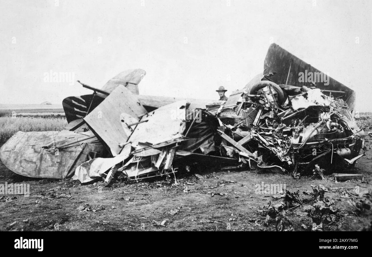 An American soldier checks crashed U.S. airplane during World War I, ca. 1918. Stock Photo