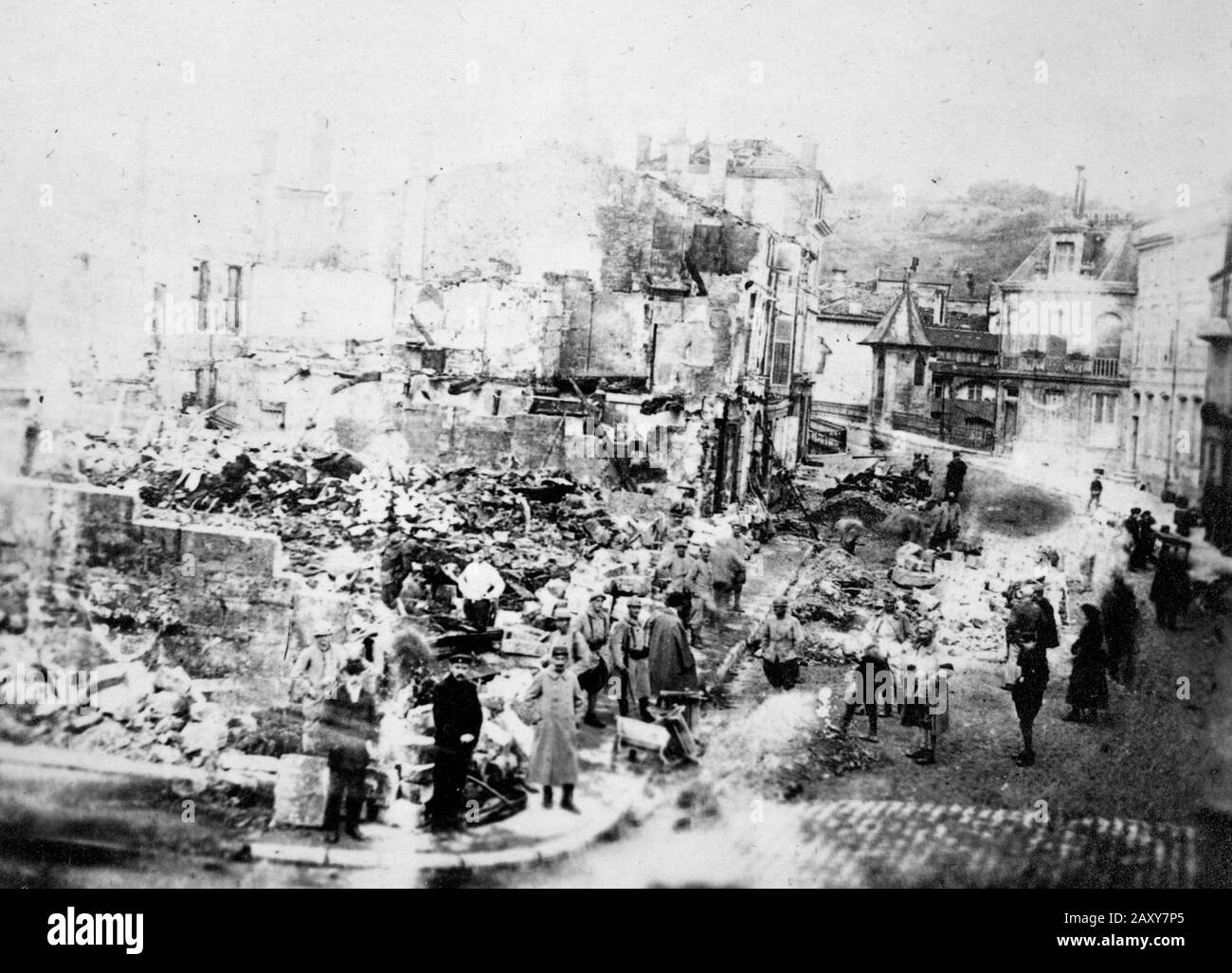 A crowd gathers in what's left of a French village after bombardment during World War I, ca. 1918. Stock Photo