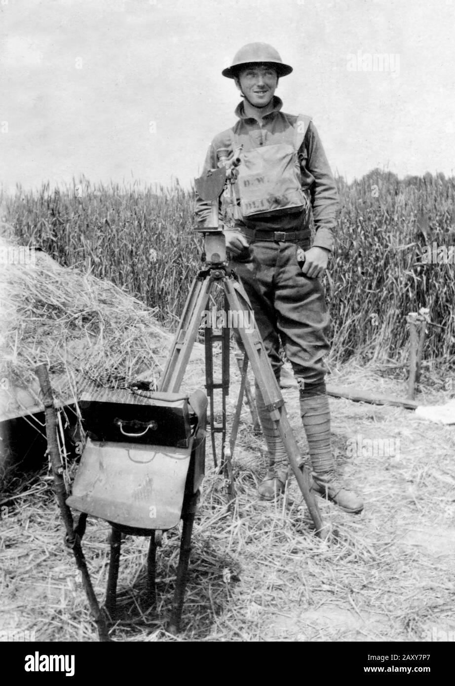 A soldier in World War I stands by a piece of surveying equipment, ca. 1918. Stock Photo