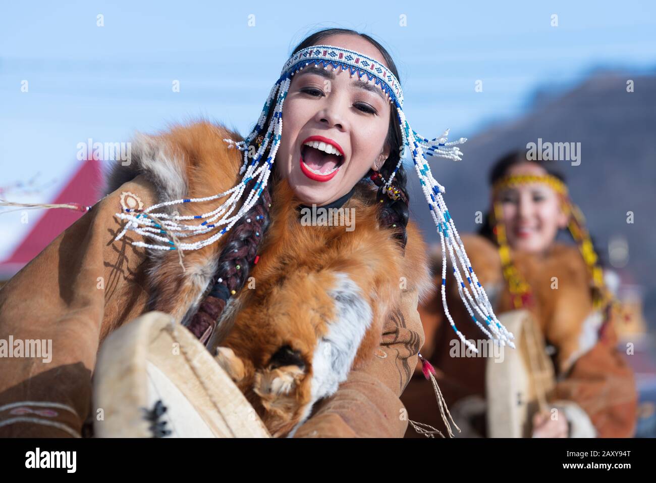 Female dancing with tambourine in national clothing indigenous