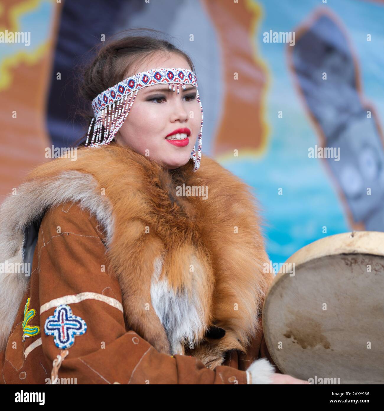 Girl dancing with tambourine in tradition clothing aborigine people Kamchatka Peninsula