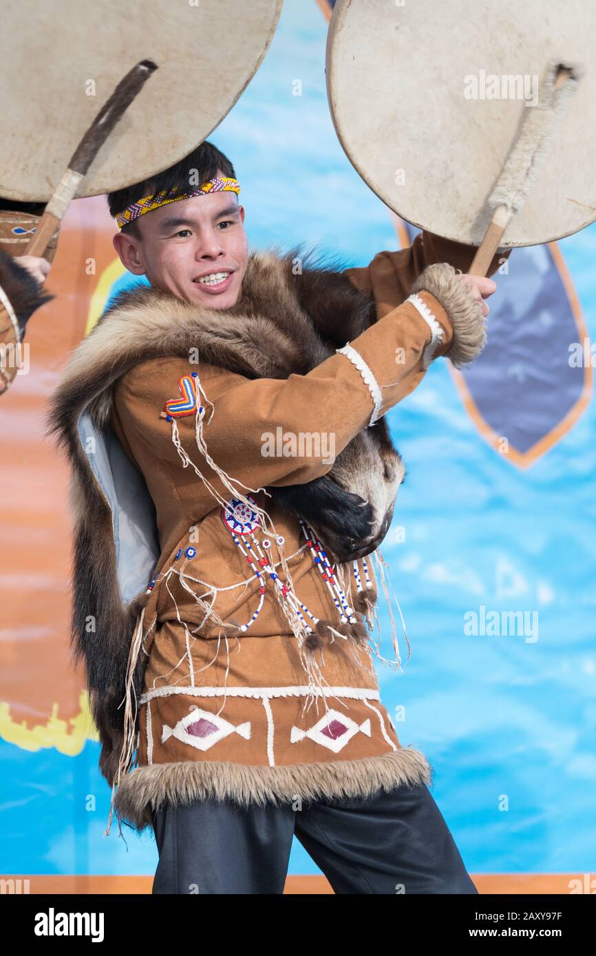 Male expression dancing with tambourine in tradition clothing indigenous inhabitants Kamchatka. Celebration Koryak national holiday Hololo Day of Seal Stock Photo