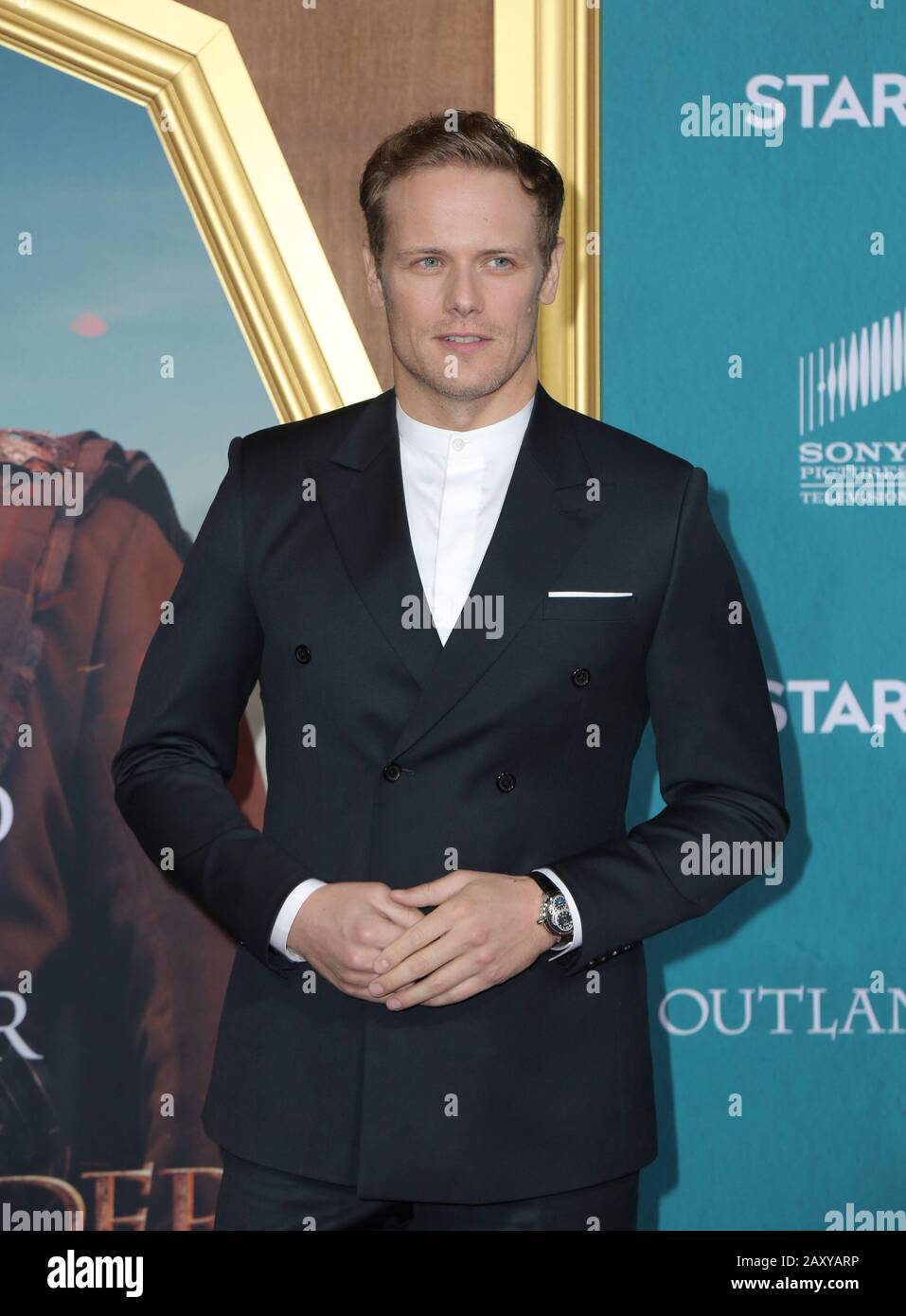 Sam Heughan walking the red carpet at the Starz Premiere Event For "Outlander" Season 5 held at