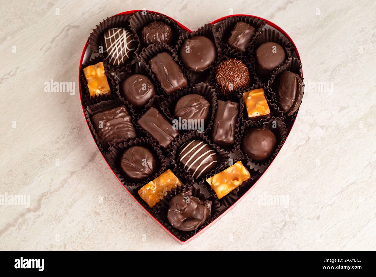 Delicious chocolates in a heart shaped box Stock Photo Alamy