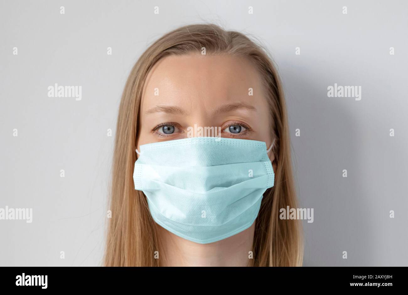 Light hair woman wearing medical mask for protection against virus Stock Photo