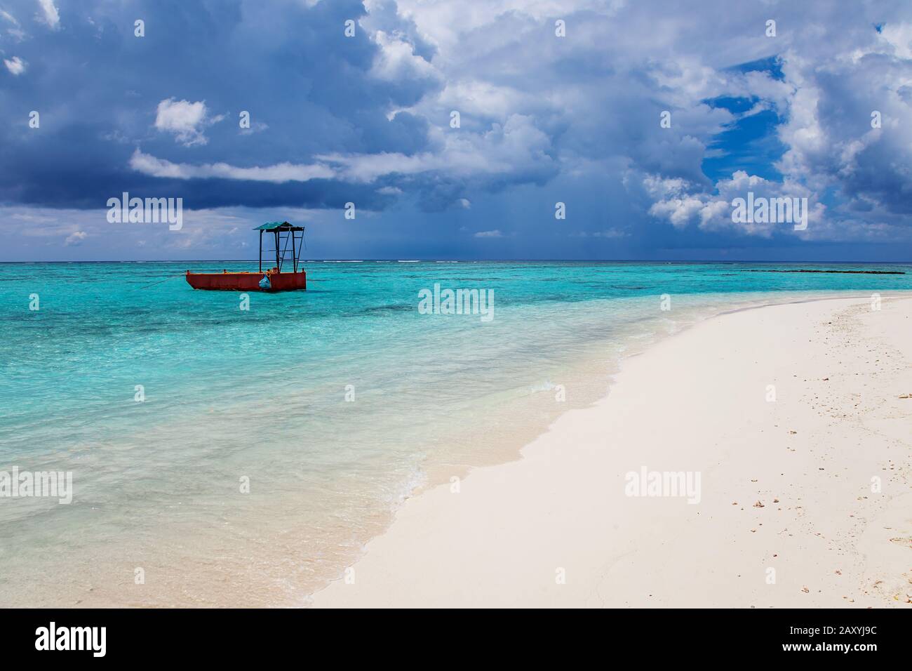 Turquoise blue sea water shore and cloudy sky Stock Photo - Alamy