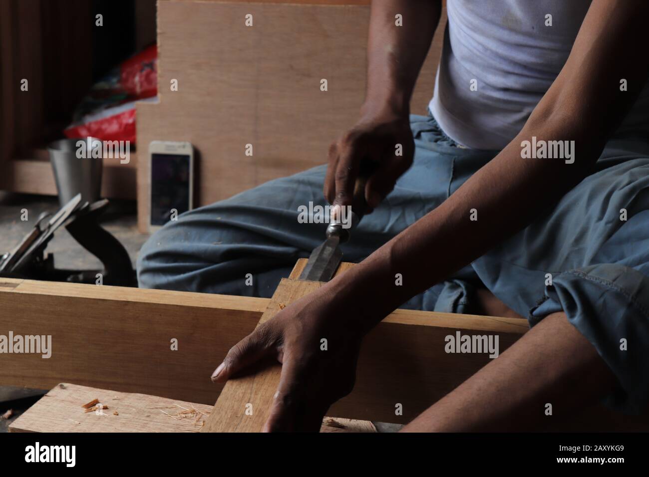 Carpenter working with gouge on table in his workshop Stock Photo - Alamy