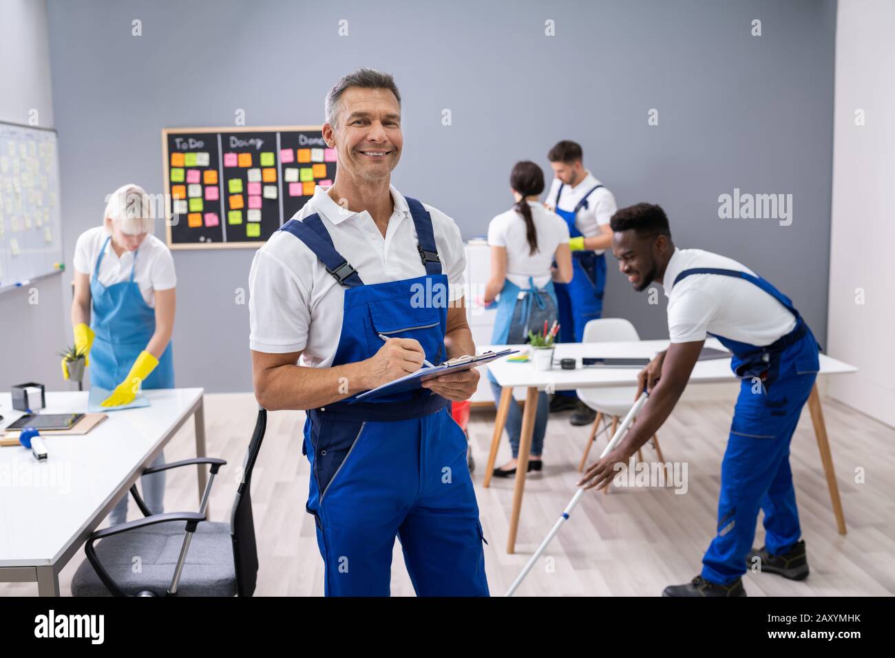 Janitor With His Team Cleaning Modern Office Stock Photo Alamy