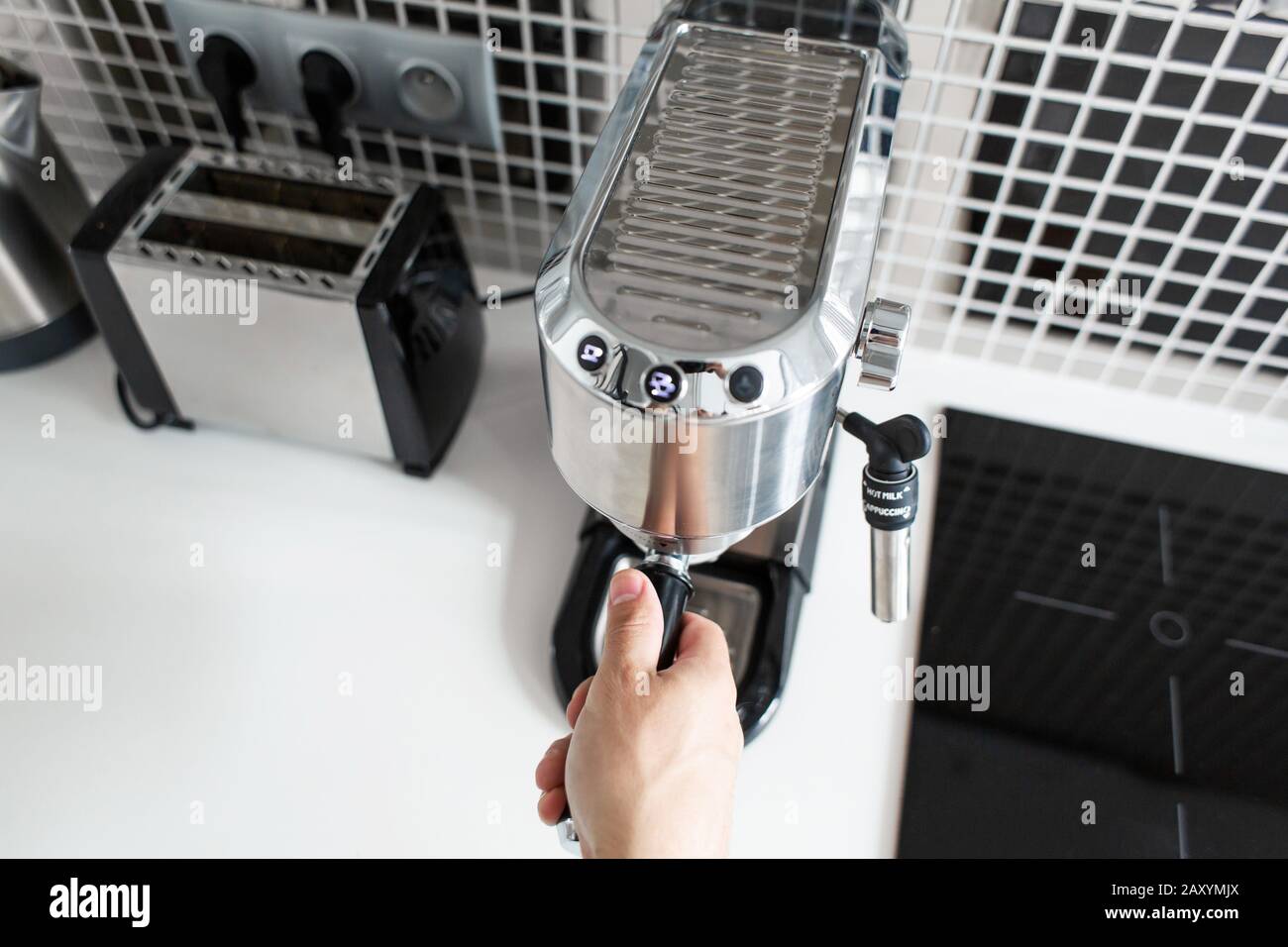 Guy prepare delicious aromatic coffee in a coffee machine. A simple way