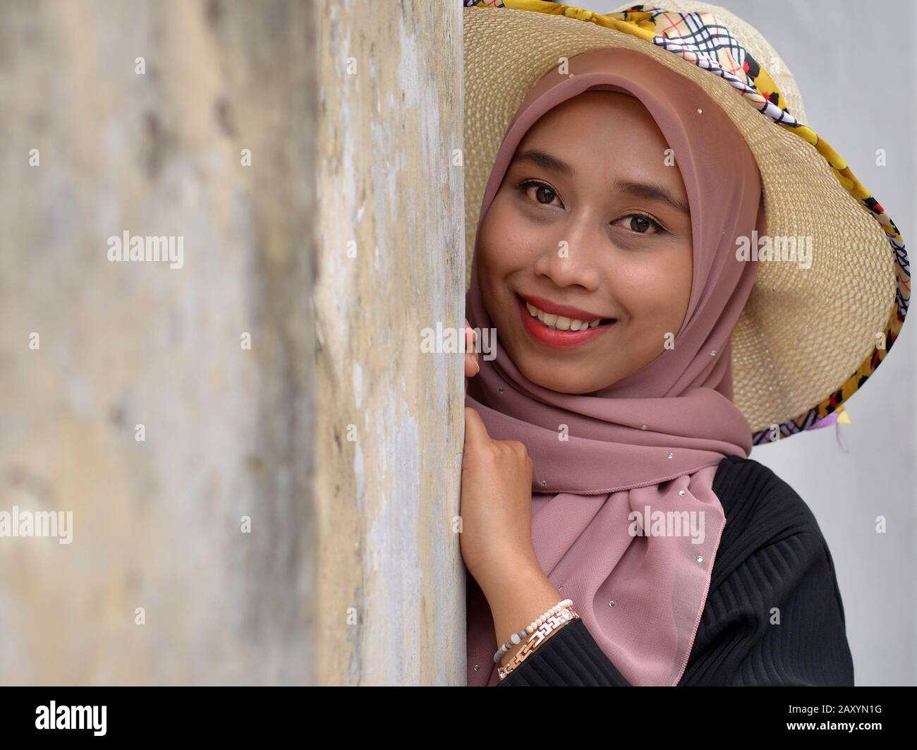 Beautiful Young Malaysian Malay Woman Wears A Modern Sun Hat With Her Traditional Hijab And Smiles For The Camera Stock Photo Alamy