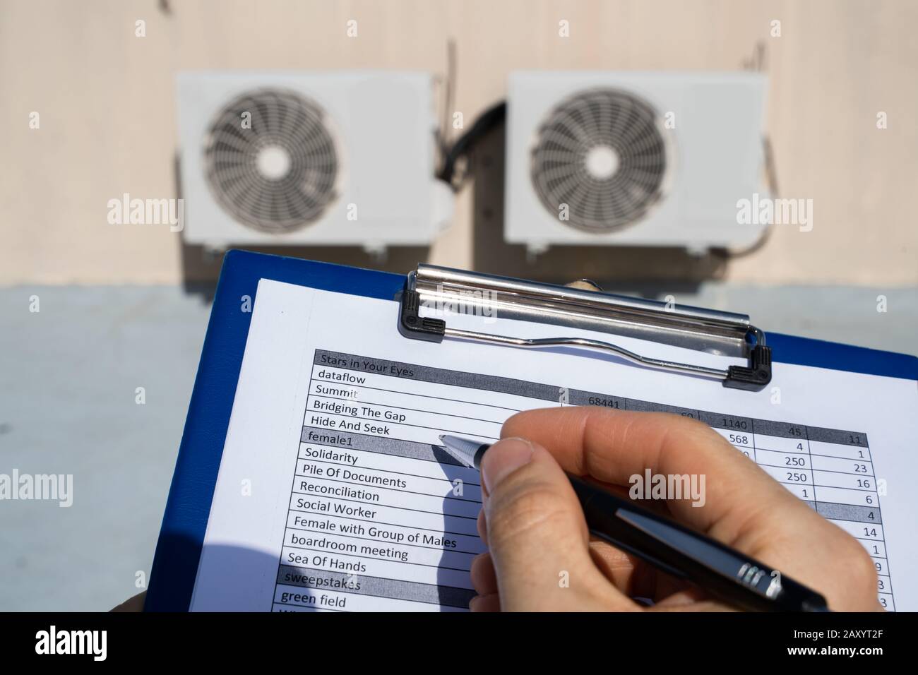 Man Doing Heating, Ventilation, And Air Conditioning Inspection Stock Photo