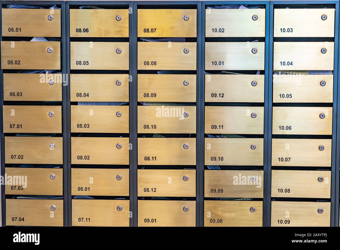 Metallic letter mailboxes at postal room in condominium building Stock