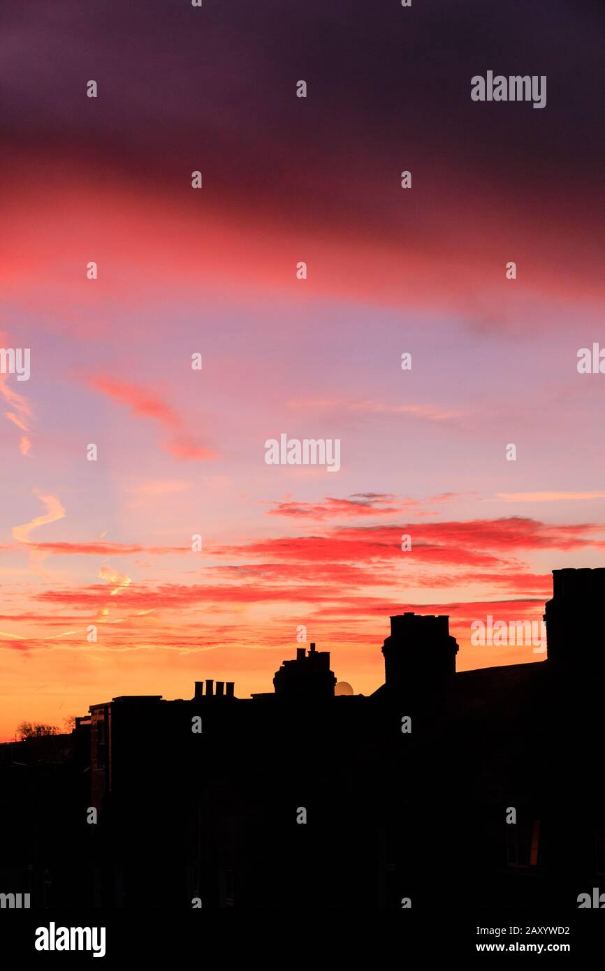 London, UK. 14th Feb, 2020. A beautiful red and orange sunrise with colourful cloud formations appears over the roof tops of South East London, just in time for Valentine's Day 2020. Credit: Imageplotter/Alamy Live News Stock Photo