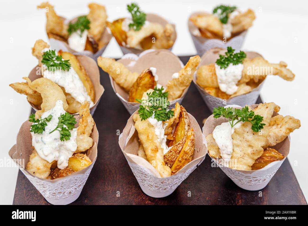 Fish and chips served in paper cones for individual serving. Decorated