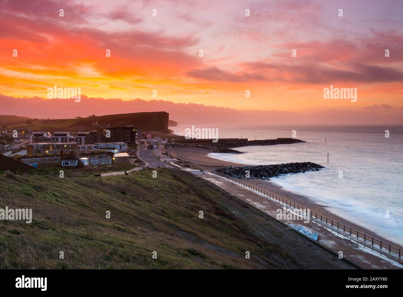West Bay, Dorset, UK.  14th February 2020. UK Weather.  A red sky at dawn on valentines day shortly before sunrise at West Bay in Dorset ahead of the forecast bad weather from Storm Dennis.  Picture Credit: Graham Hunt/Alamy Live News Stock Photo