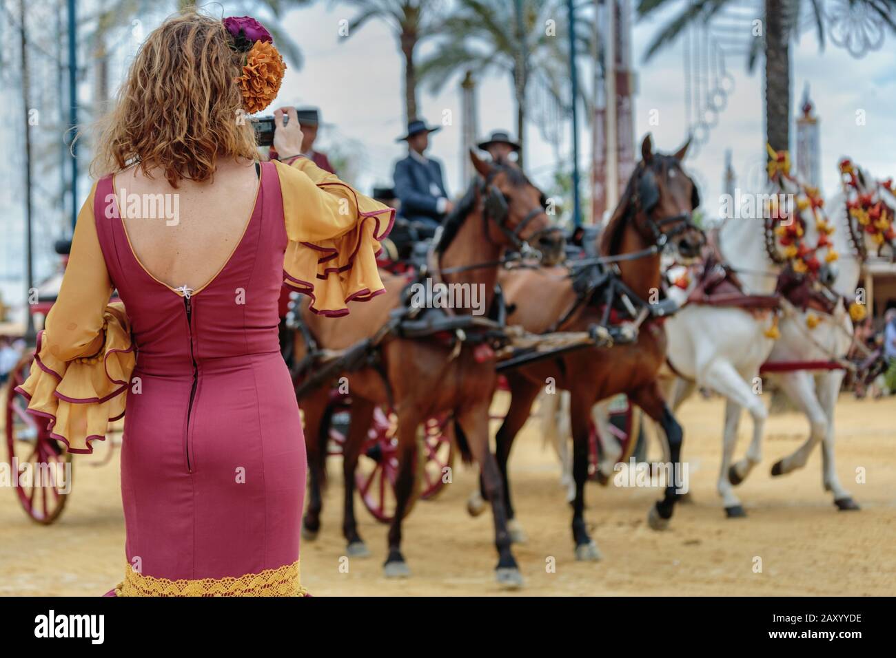 Back of woman wearing traditional Spanish dress, Jerez Horse Fair (Feria de Caballo) , Jerez de la Frontera, Cádiz Province, Andalusia, Spain Stock Photo