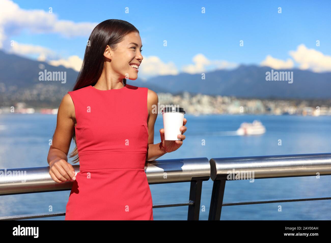 Happy multiethnic business woman enjoying her morning coffee at work break in beautiful nature view in vancouver city, downtown. Urban lifestyle, businesspeople working in coal harbour. Stock Photo